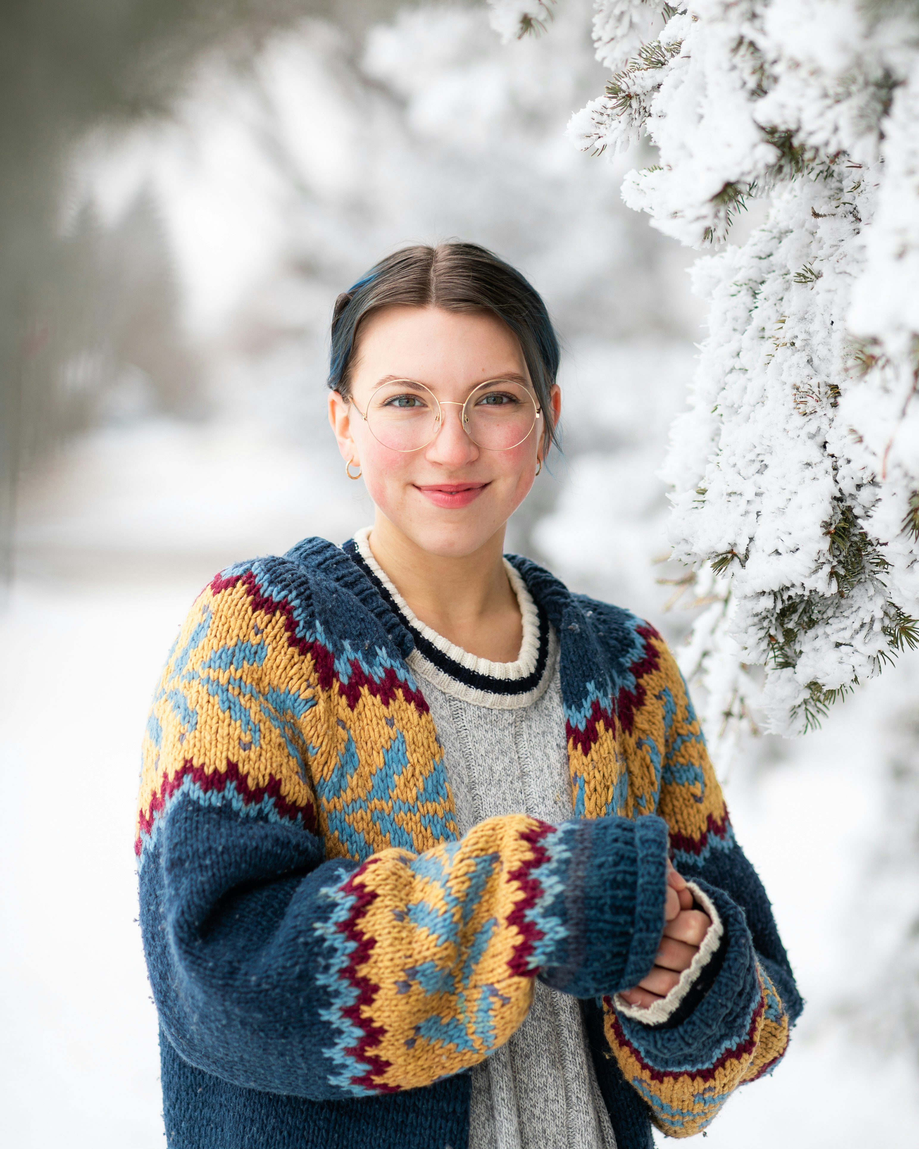 woman in blue and white sweater smiling